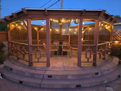 a wooden gazebo with a table and chairs at 3 BEDS house with pool in National City