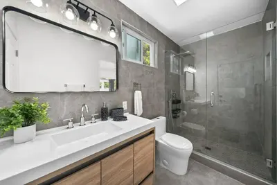 a bathroom with a sink and a toilet and a shower at Pool, Hot Tub, Luxury 3 Beds,15 Min Beach,DT, Zoo, Sesame Place, Airport in National City