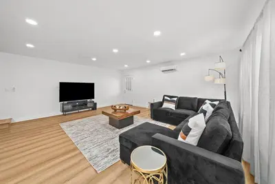 a living room with a couch and a tv at Pool, Hot Tub, Luxury 3 Beds,15 Min Beach,DT, Zoo, Sesame Place, Airport in National City