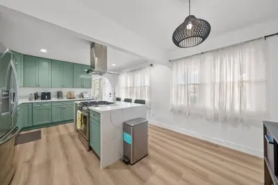 a kitchen with green cabinets and a counter top at Pool, Hot Tub, Luxury 3 Beds,15 Min Beach,DT, Zoo, Sesame Place, Airport in National City