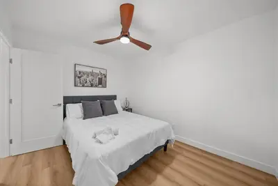 a bedroom with a bed with a ceiling fan at Pool, Hot Tub, Luxury 3 Beds,15 Min Beach,DT, Zoo, Sesame Place, Airport in National City
