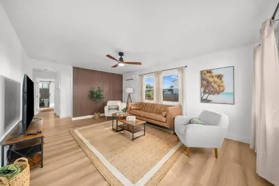 a living room with a couch and a tv at Pool, Hot Tub, Luxury 3 Beds,15 Min Beach,DT, Zoo, Sesame Place, Airport in National City