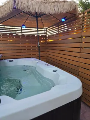 a jacuzzi tub with an umbrella in a backyard at Pool, Hot Tub, Luxury 3 Beds,15 Min Beach,DT, Zoo, Sesame Place, Airport in National City
