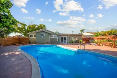 a swimming pool in front of a house at Pool, Hot Tub, Luxury 3 Beds,15 Min Beach,DT, Zoo, Sesame Place, Airport in National City