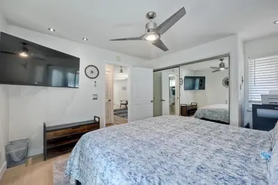 a bedroom with a bed and a clock on the wall at 1128 Tait Street, Unit D in Oceanside