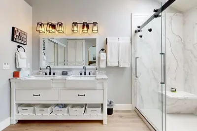 a white bathroom with a sink and a shower at Serene Outdoor Oasis Wine Country Home with Views in Glenoak Hills