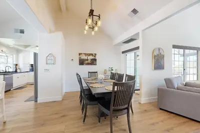 a dining room and living room with a table and chairs at Serene Outdoor Oasis Wine Country Home with Views in Glenoak Hills