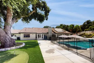 a house with a swimming pool and a tree at Serene Outdoor Oasis Wine Country Home with Views in Glenoak Hills