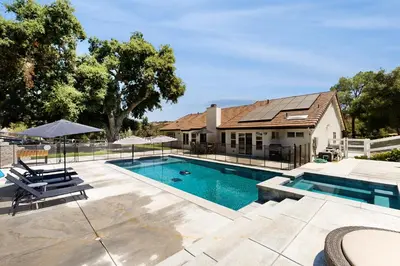 a house with a swimming pool in front of a house at Serene Outdoor Oasis Wine Country Home with Views in Glenoak Hills