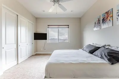 a bedroom with a bed and a ceiling fan at Vista Grande home in Ramona