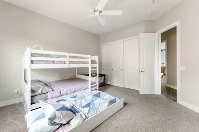 a bedroom with two bunk beds and a ceiling fan at Vista Grande home in Ramona
