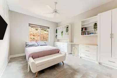 a white bedroom with a bed and a window at Vista Grande home in Ramona