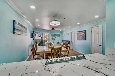 a kitchen and dining room with a table and a dining room at Beach Front Paradise - Entire Condo- Crystal Pier in San Diego