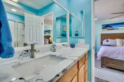 a bathroom with a tub and a bedroom with a bed at Beach Front Paradise - Entire Condo- Crystal Pier in San Diego