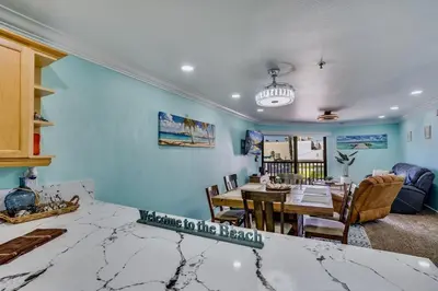 a kitchen and dining room with a table and chairs at Beach Front Paradise - Entire Condo- Crystal Pier in San Diego