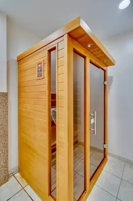 a bathroom with a wooden door in a room at Pacific Beach Resort Condo - Walk to the Beach in San Diego