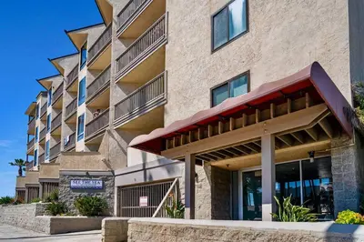 an image of a building with a sign in front of it at Beach Front Bliss - Entire Condo - Crystal Pier in San Diego