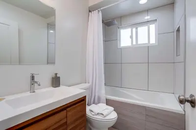 a bathroom with a sink and a toilet and a shower at A-C 3 Blocks to Ocean Downtown La Jolla Remodel in San Diego