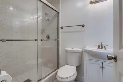 a bathroom with a shower and a toilet and a sink at A-C 3 Blocks to Ocean Downtown La Jolla Remodel in San Diego