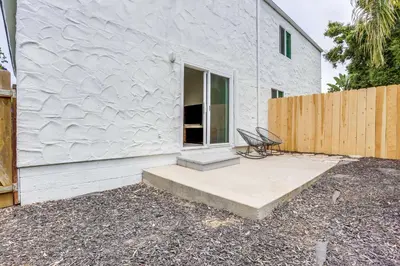a white building with a chair sitting on a patio at A-C 3 Blocks to Ocean Downtown La Jolla Remodel in San Diego