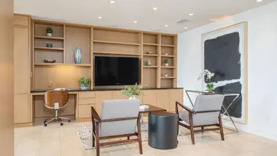 a room with a desk with chairs and a tv at Jewel by AvantStay Panoramic Ocean Views in La Jolla in San Diego