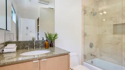 a bathroom with a sink and a shower at Jewel by AvantStay Panoramic Ocean Views in La Jolla in San Diego