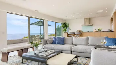 a living room with a couch and a table at Jewel by AvantStay Panoramic Ocean Views in La Jolla in San Diego