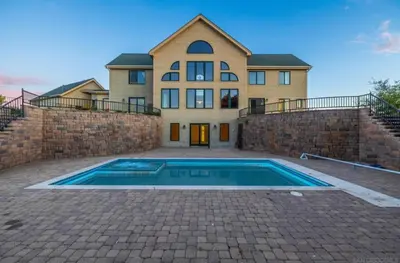 a large house with a swimming pool in front of it at Sunset-Ridge in Alpine