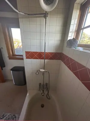 a bath tub in a bathroom with red and white tiles at Sunset-Ridge in Alpine