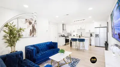 a living room with blue couches and a kitchen at Xlnc Home 3bed2bath by sdstay in Lemon Grove