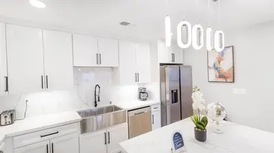 a kitchen with white cabinets and a stainless steel refrigerator at Xlnc Home 3bed2bath by sdstay in Lemon Grove