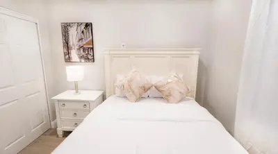 a white bedroom with a white bed with pillows at Xlnc Home 3bed2bath by sdstay in Lemon Grove