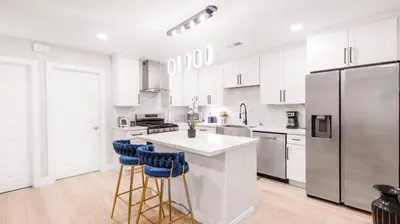 a kitchen with white cabinets and a stainless steel refrigerator at Xlnc Home 3bed2bath by sdstay in Lemon Grove