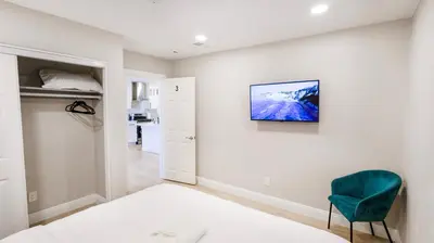a bedroom with a bed and a blue chair at Xlnc Home 3bed2bath by sdstay in Lemon Grove