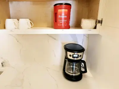 a coffee maker sits on a shelf in a cupboard at Xlnc Home 3bed2bath by sdstay in Lemon Grove