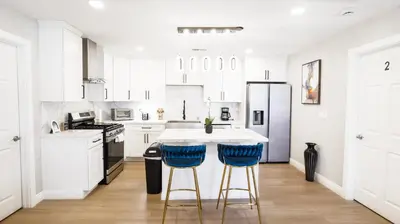 a kitchen with white cabinets and blue bar stools at Xlnc Home 3bed2bath by sdstay in Lemon Grove