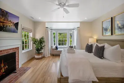 a bedroom with a large bed and a fireplace at Luxury Ocean View Retreat in San Diego