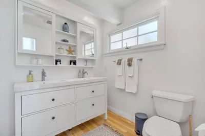 a white bathroom with a sink and a toilet at Luxury Ocean View Retreat in San Diego