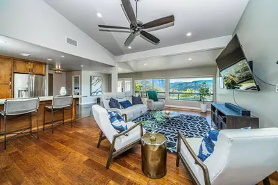 a large living room with a couch and a table at Lakeside Hilltop Retreat with Amazing Pool and Spa in Lakeside