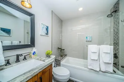 a bathroom with a tub and a toilet and a sink at Lakeside Hilltop Retreat with Amazing Pool and Spa in Lakeside
