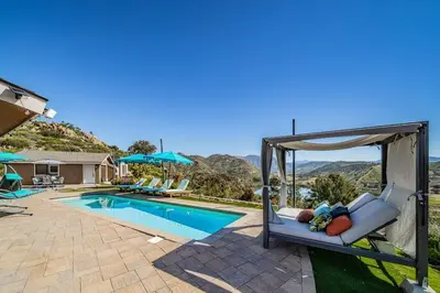 a swimming pool with a gazebo next to a house at Lakeside Hilltop Retreat with Amazing Pool and Spa in Lakeside