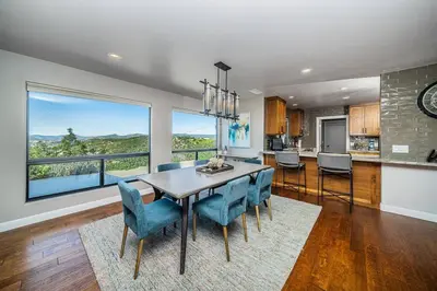 a kitchen and dining room with a table and chairs at Lakeside Hilltop Retreat with Amazing Pool and Spa in Lakeside