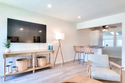 a living room with a table with a mirror at Beachside Bliss Spacious 3BR Retreat, Steps to Ocean in Oceanside
