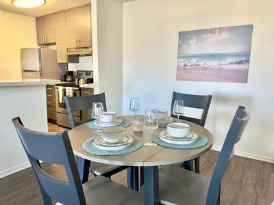 a dining room with a table and chairs in a kitchen at Cozy Coastal Retreat Newport Beach in Newport Beach