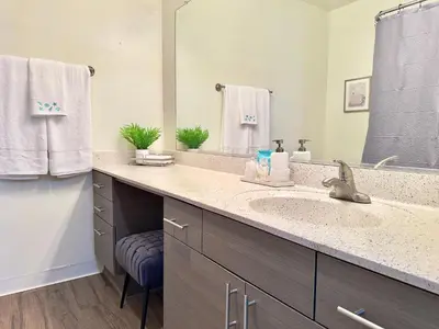 a bathroom with a sink and a large mirror at Cozy Coastal Retreat Newport Beach in Newport Beach