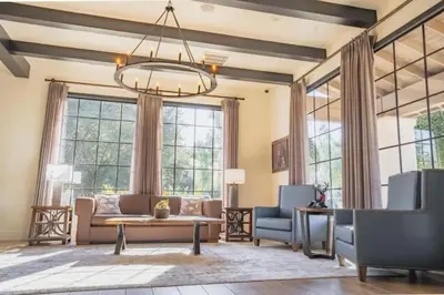 a living room with a couch and chairs and windows at Diamond Riviera Oaks Resort and Racquet Club 1BD in Ramona