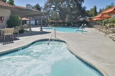 a swimming pool with blue water in a resort at Diamond Riviera Oaks Resort and Racquet Club 1BD in Ramona
