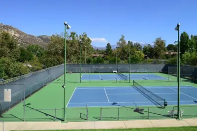 a tennis court with two tennis courts at Diamond Riviera Oaks Resort and Racquet Club 1BD in Ramona
