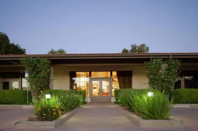 a building with a door and some bushes at Diamond Riviera Oaks Resort and Racquet Club 2BD in Ramona
