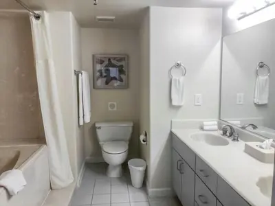 a white bathroom with a toilet and a sink at Diamond - Riviera Beach and Spa Resort 1bd in Dana Point